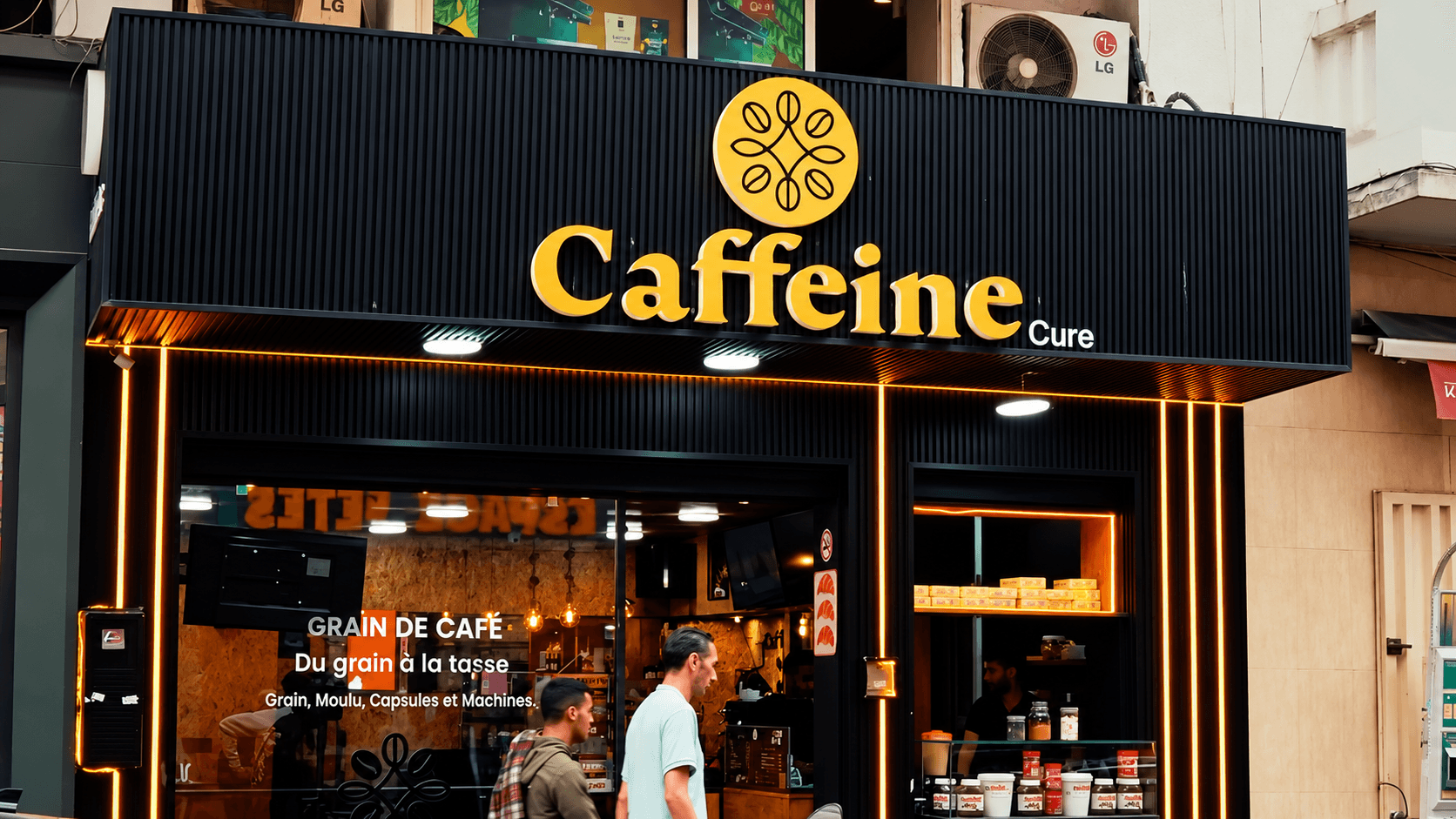 Caffeine Cure's gold sign above the café entrance